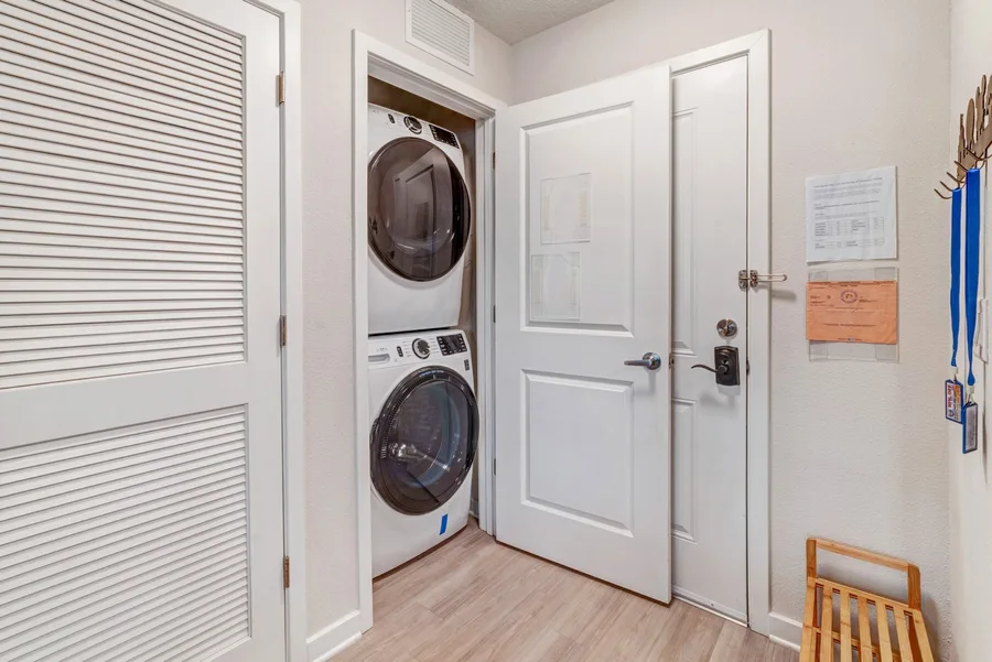 Washer and dryer stacked in a closet