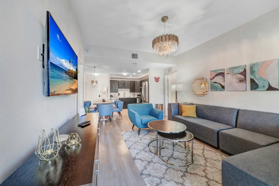 Living room with sofa, TV and woven rug