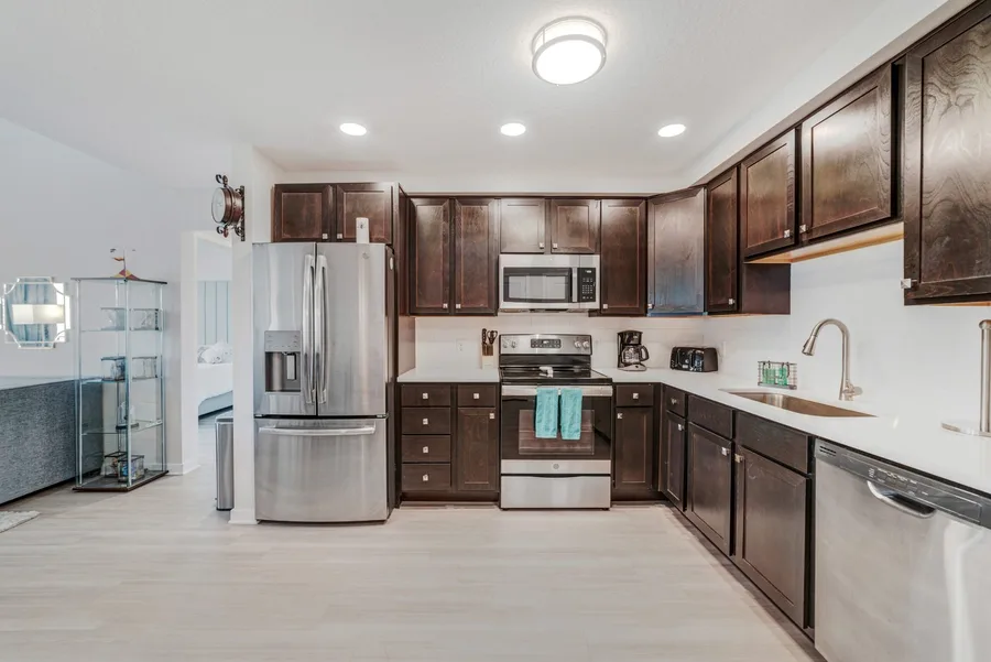 Kitchen with dark cabinets and stainless steel
